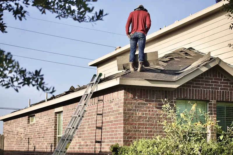 Professional roofer working on a residential roof in Manatee Harbor